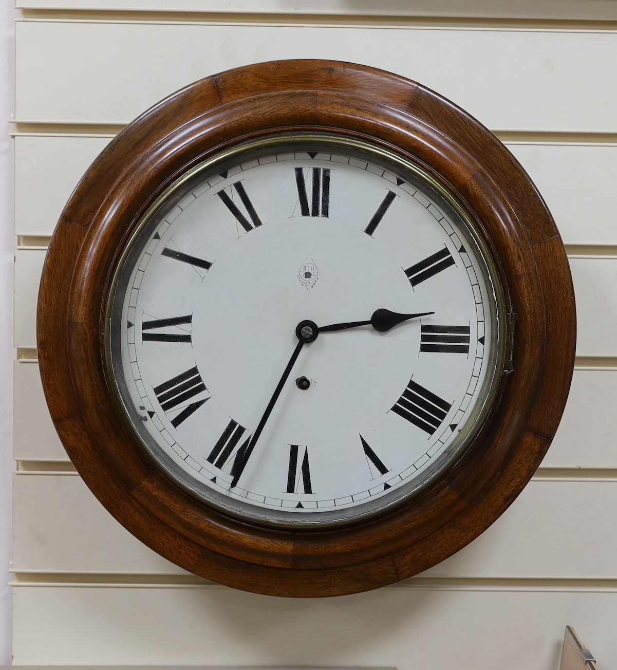 A mahogany dial clock - with key and pendulum, 44cm diameter